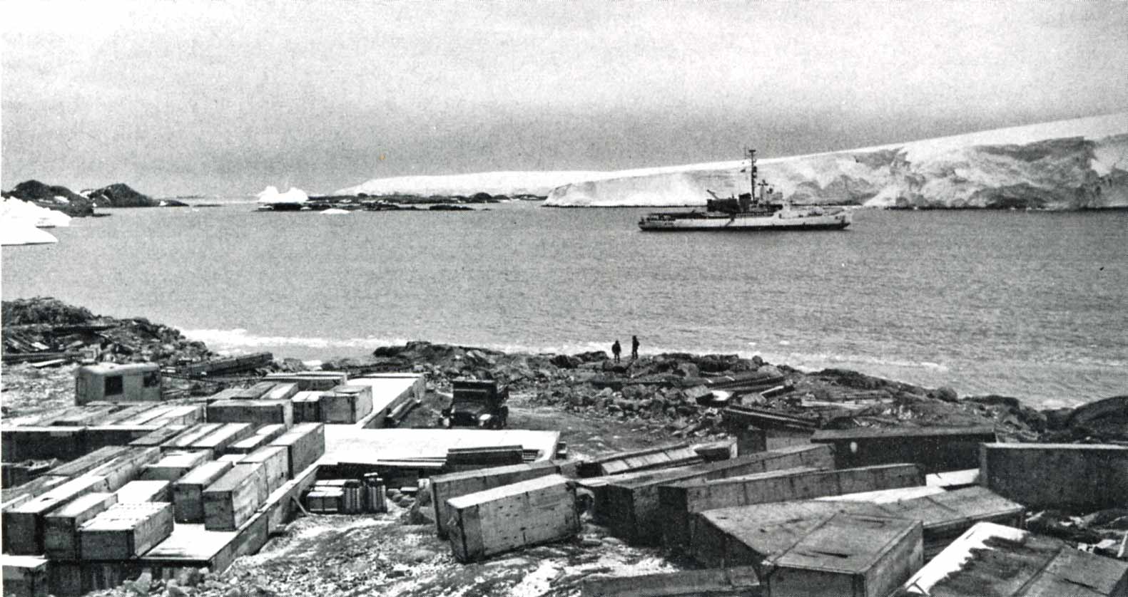 The Coast Guard Cutter Westwind at anchor in Arthur Harbor in winter 1967, after arriving on January 8 with a team of Navy Seabees. After transferring the team and several tons of gear ashore, the Westwind stayed on station as construction began on Palmer Station. Photo from the Palmer Station history pages at palmerstation.com.