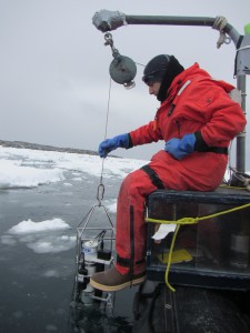 Austin Melillo, a geology student at Rutgers University, helps deploy the LTER CTD (conductivity, temperature, and depth) package amid sea ice at Station B.
