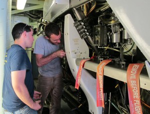 Alvin techs Logan Driscoll (left) and Jefferson Grau work on the sub's variable ballast system. 