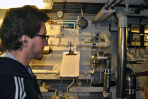 Matt inspects the desalinators, which rapidly boil and condense seawater to produce clean fresh water for use on board