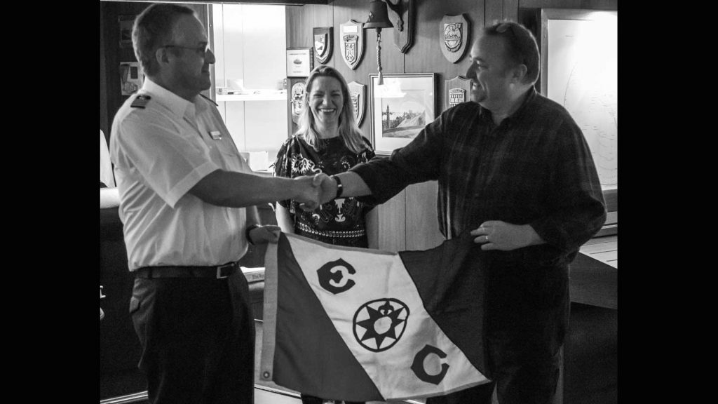 Hands across the sea. Captain Stefan Schwarze, Shief Scientist Prof. Dr. Antje Boetius, and blog author Chris German celebrating the end of their expedition together with Explorers Club Flag 80. It was not lost on the NUI team that Capt. Schwarze insisted that this should only be "auf wiedersehen," (literally, "see you again") not "goodbye." Should we come back with a deeper-diving NUI and find those vents? (photo by Martin Schiller, AWI)