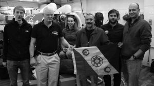 My Heroes. The people who made NUI work, sporting Flag 80 of the Explorers Club in front of NUI aboard Polarstern following NUI Dive 16 to the Karasik Seamount in the Arctic Ocean. From left to right: Andrew Branch, Louis Whitcomb, Casey Machado, John Bailey, Stefano Suman and Mike Jakuba. (photo by Chris German, Woods Hole Oceanographic Institution)