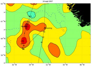 This figure shows the probable locations of several Irminger Rings in color shading. The data are from a satellite that measures sea surface height. Just like high and low pressure systems in the atmosphere, eddies have high and low pressure at their centers. The Irminger Rings are noted by high pressure, or high sea surface height, indicated here by red colors. These measurements of eddy locations are only approximate. We had to verify the locations of eddies using temperature profilers called Expendable Bathythermographs, or XBTs. As we approached the mooring site from the southwest, we released several XBTs to find out if the weak high pressure at that site was an eddy. Turned out it wasn't. After putting the mooring in, we steamed down to the southwest where there were two more high pressure systems. We started releasing XBTs along a path cutting through both possible eddies. You can see that the *'s, which mark the locations of the XBT profiles, are not right on the planned cruise track (the thin black line). This is because the wind was blowing so hard, and the waves were so big, that the ship could not follow the planned track exactly. The temperature profiles in the first of the two eddies were inconclusive. So we went on to the second one. Here the temperature probes showed an eddy was present at the same location as the high pressure. So we released one of our floats at the place where we think the eddy center was located. Within hours, the float had started its programmed mission, profiling up and down in the eddy. We hope the float will stay with this eddy and tell us where the eddy goes and how its core properties change with time. (Map by Amy Bower, Woods Hole Oceanographic Institution)