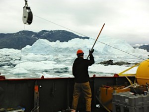 Nick Beaird fending ice off of the lines in August 2013 during a mooring recovery.