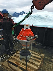 A PIES deployment in Sermilik in August 2013 with an on-the-fly modification: a pallet strapped to the bottom of the anchor stand to prevent the instrument from sinking into the oozy bottom.   At sea we’re usually prepared to “McGyver” things together (albeit in this case without duct tape).