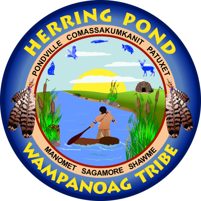 Multi color round seal. The outer ring of the seal says Herring Pond Wampanoag Tribe. The inner ring lists Pondville, Comassakumkanit, Patuxet, Manomet, Sagamore, and Shawme, with feathers on either side. The inner disk shows a tribe member paddling on a river, the sun rising on the horizon. In the sky are blue animal shapes, including deer, turtle, and fish.