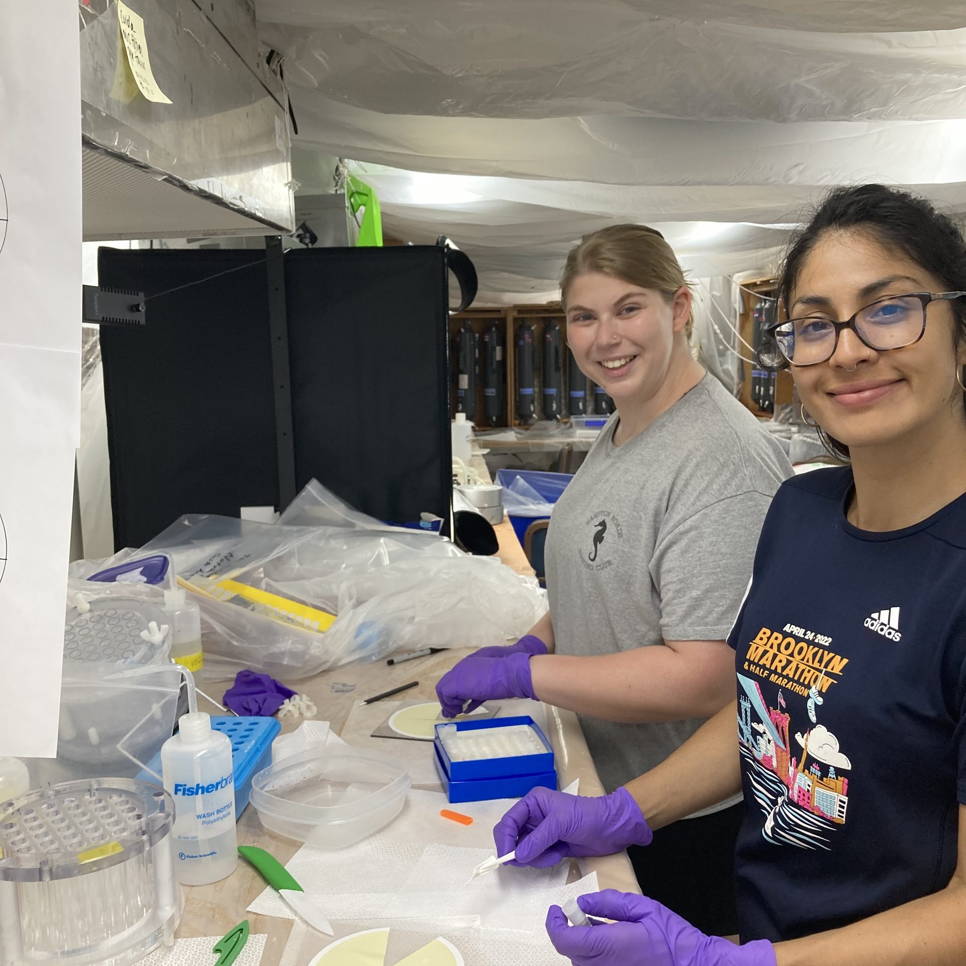 Paloma Lopez (research technician in Mak Saito's lab) and Emily Burdige (JP Student in Mak Saito and Adam Subhas' labs) processing filter samples at 3AM on the RV Atlantis. Photo credit Mak Saito.
