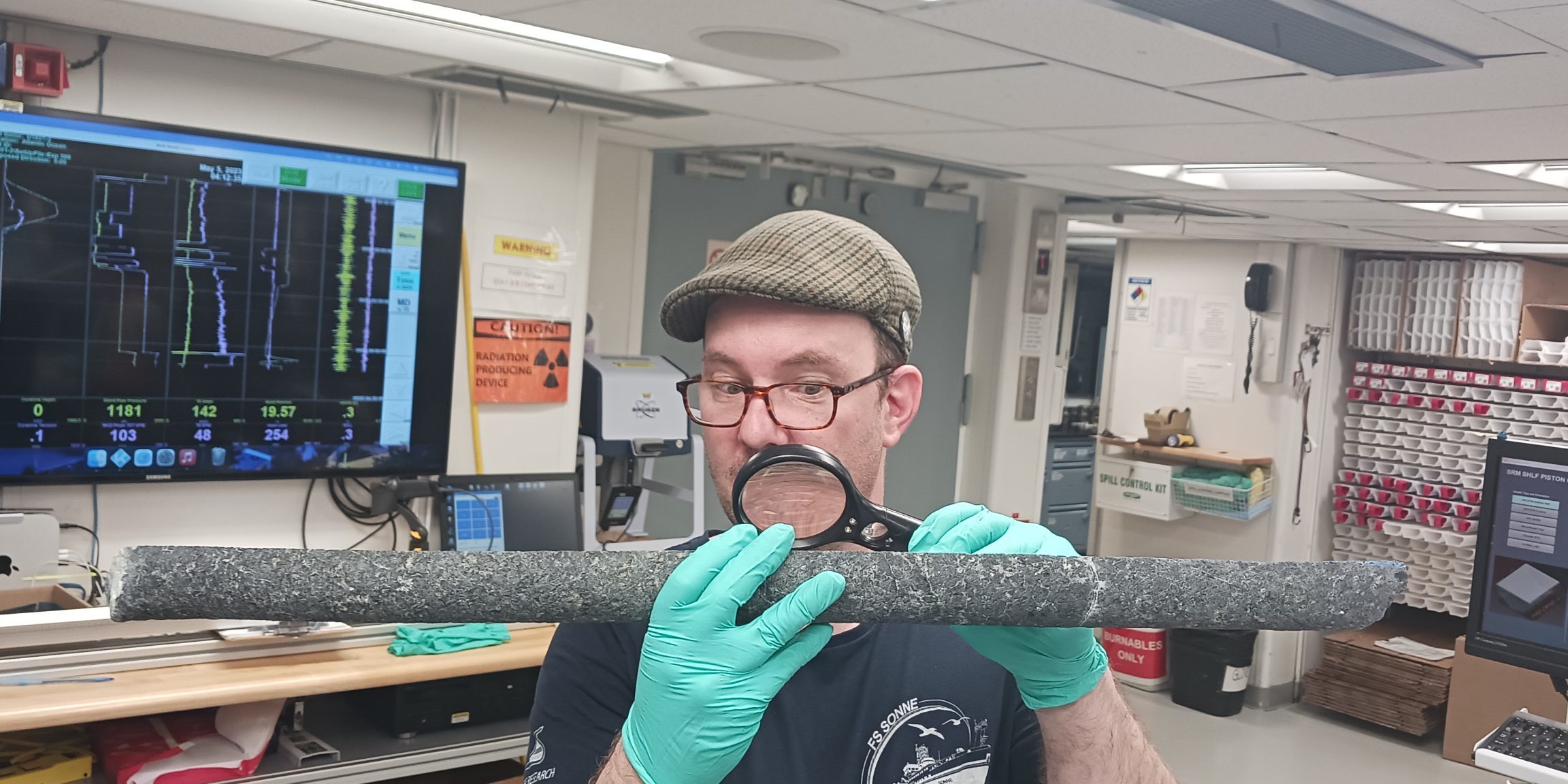Frieder looking intensely at a mantle rock core on board the JOIDES Resolution for an IODP Expedition. Picture credits to Rémi Coltat. 