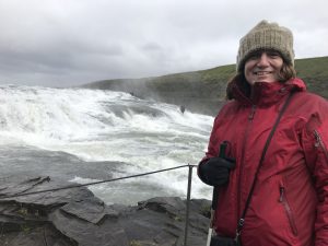 Photo of Amy standing in front of Gullfoss, at the end of the trail.