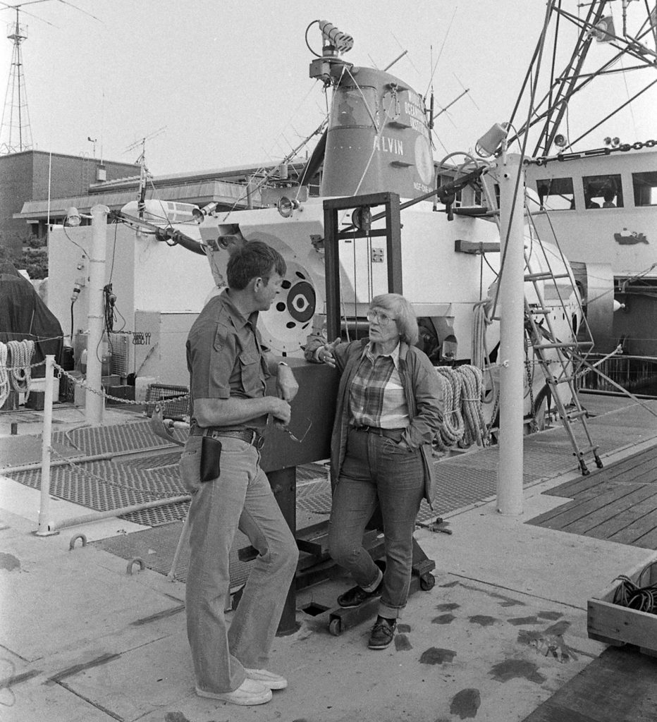 Ruth Turner discusses logistics on R/V Lulu before diving in the sub with then-Chief Alvin Pilot Ralph Hollis, Friday, August 13th, 1971. (Photo by Anne Rabushka, © Woods Hole Oceanographic Institution).